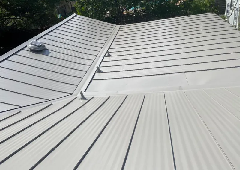 Solar attic fan installed on a metal roof for Roof Ventilation in Kill Devil Hills